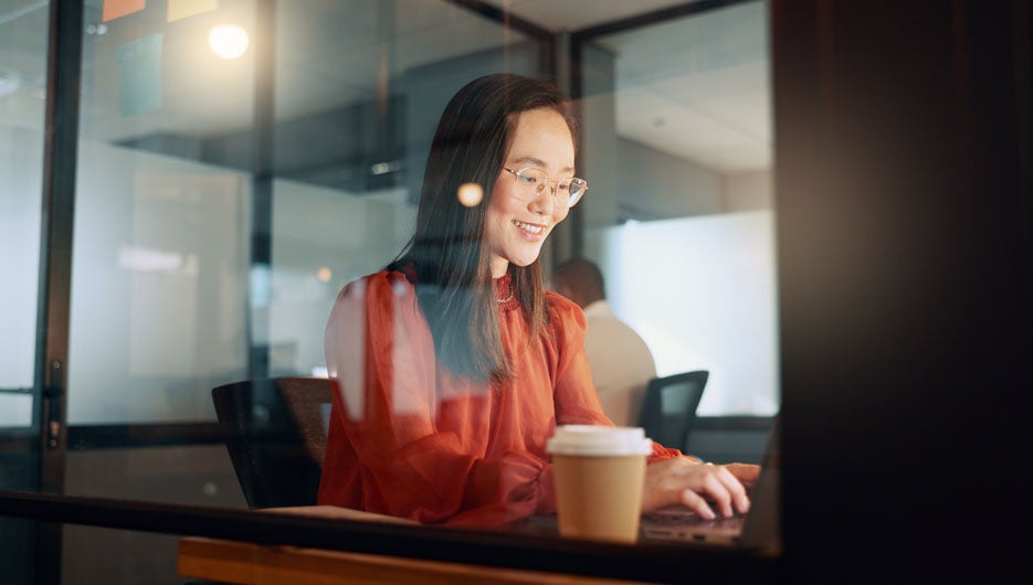 Laptop, night office and Asian woman typing email, sales proposa