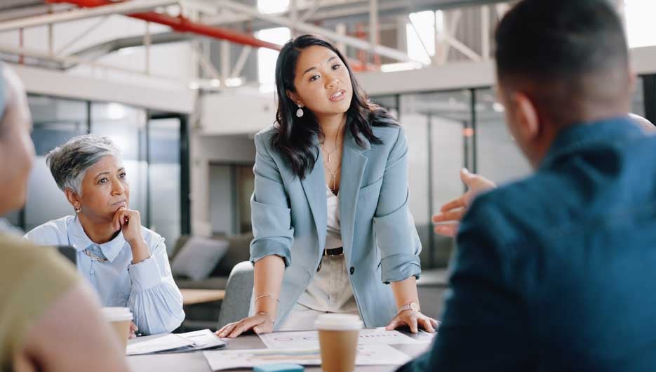 Leadership, woman or business people talking in meeting planning in discussion with vision or mission. Collaboration, question or employee speaking of project ideas in agency to team, CEO or boss.