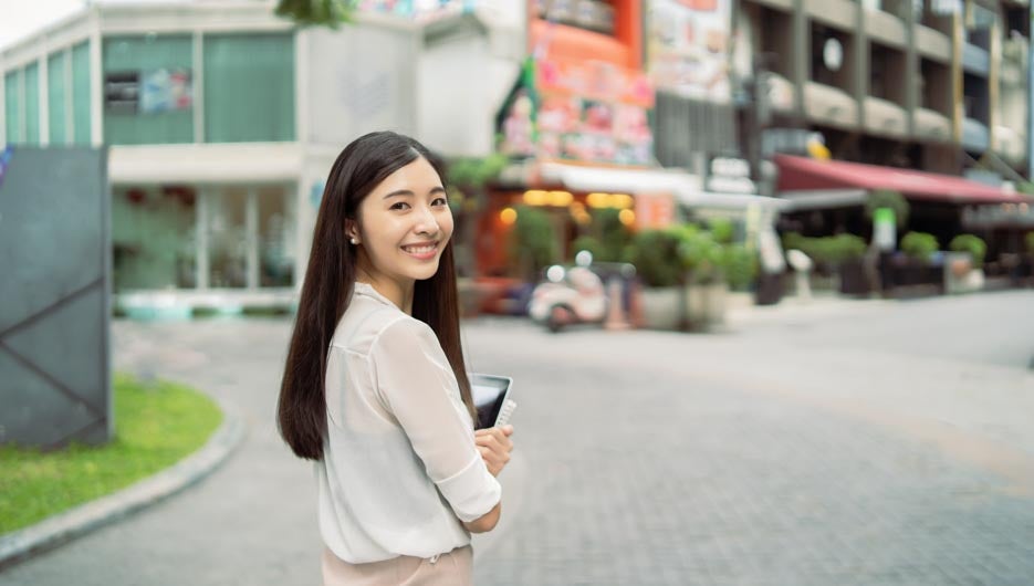 Young Asian Chinese business woman smiling and use digital table