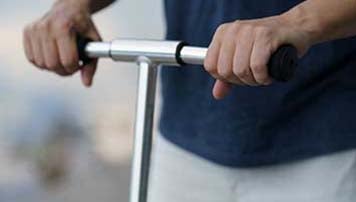 man holding scooter bars